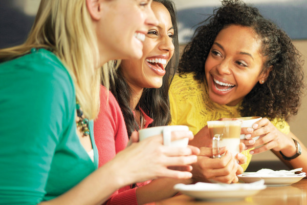 Friends laughing over coffee